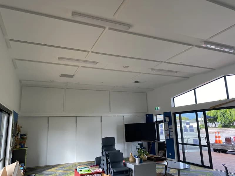 Finished white ceiling and upper-wall acoustic panels above patterned carpet in a Parklands School learning space