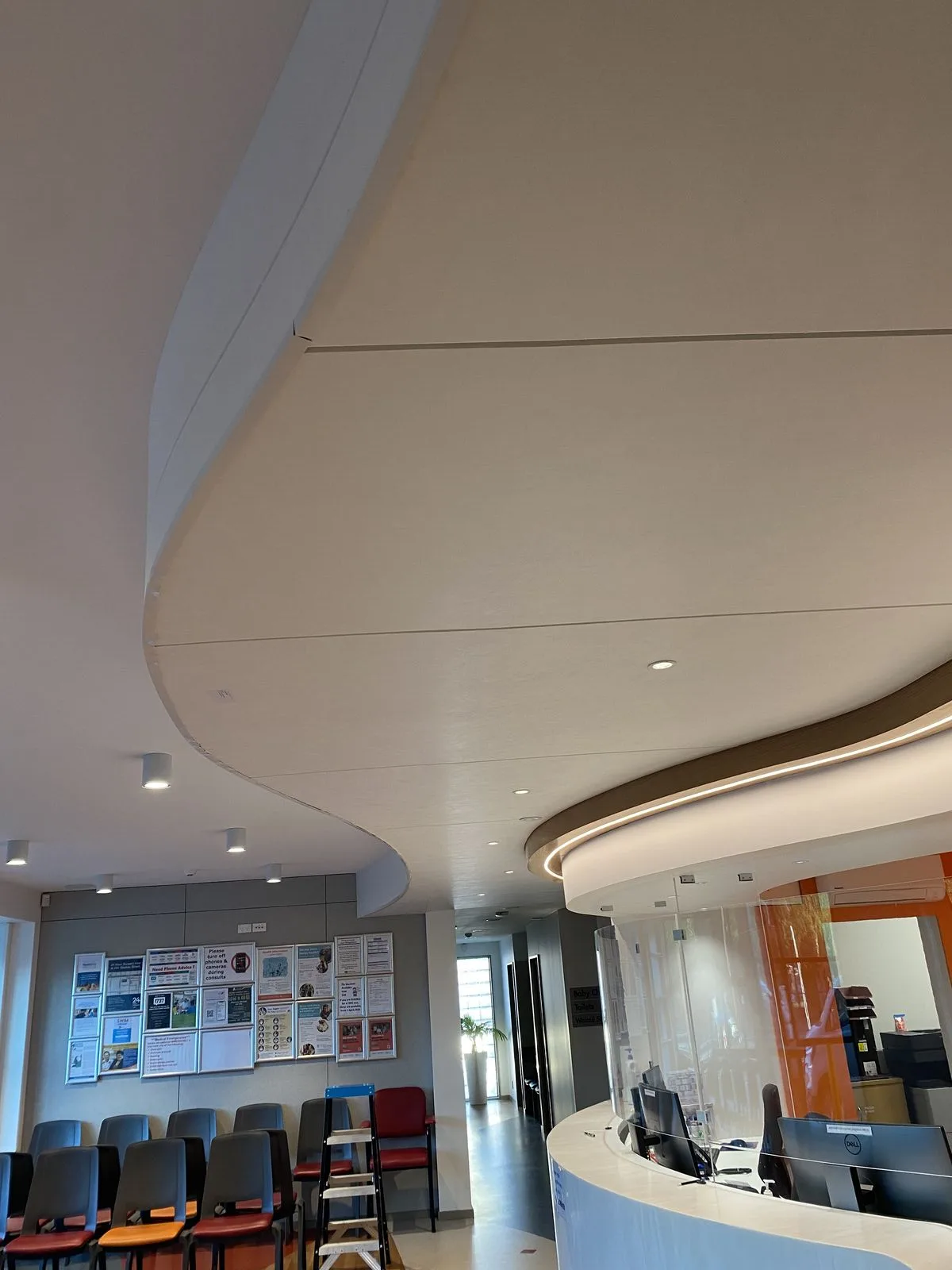 Finished curved cream wall panels and waiting chairs at Riccarton Doctors reception